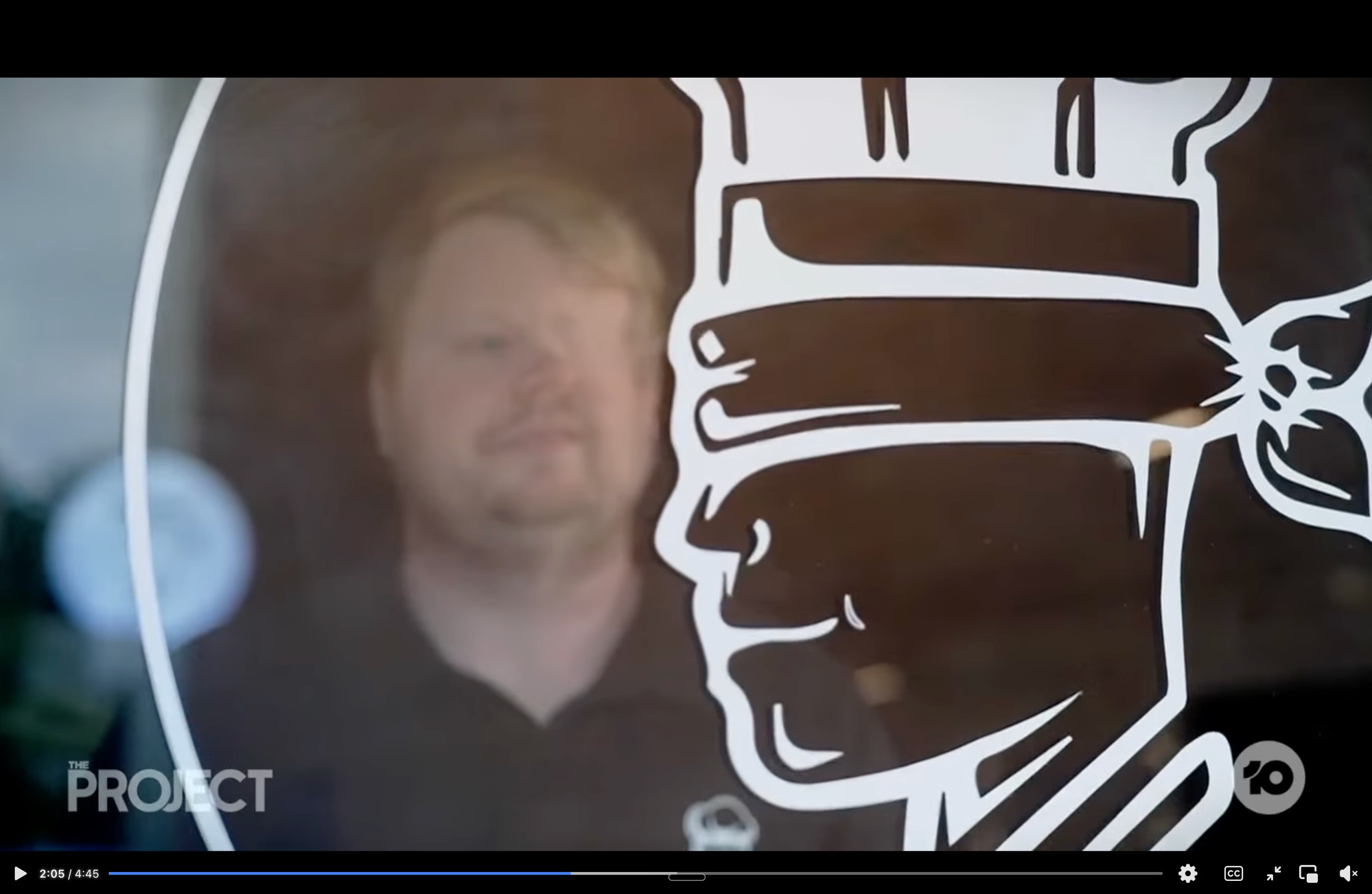 Craig Shanahan behind The Blind Chef Cafe logo, featured on The Project Channel 10